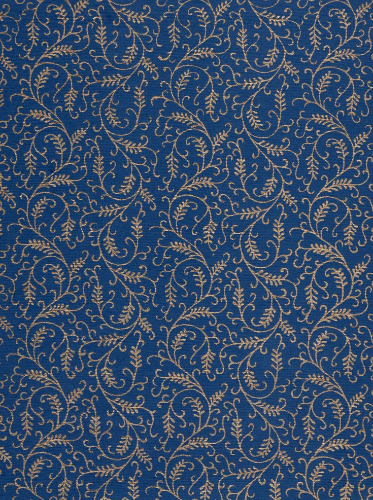 a blue and gold wallpaper with swirly vines on the bottom half of it