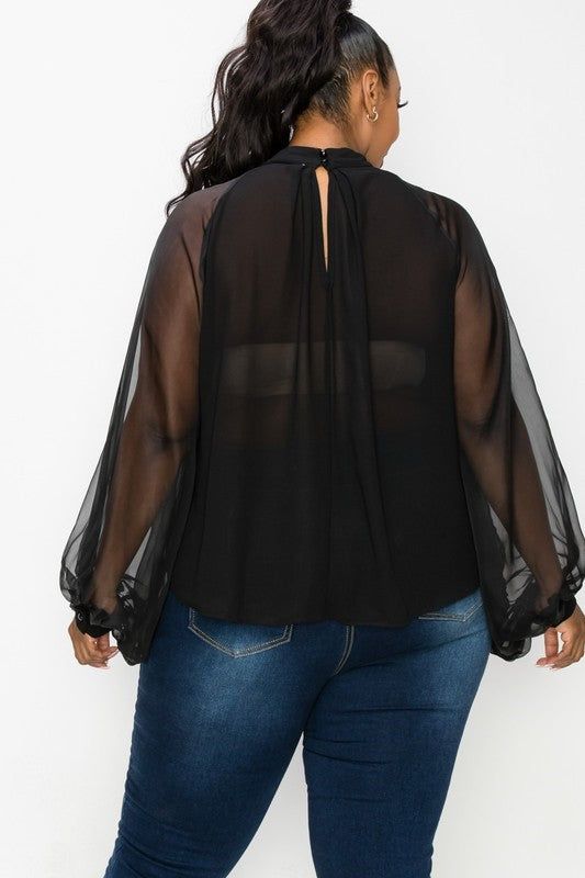 Elegant blouse with sheer back and sheer dolman sleeves. Neck line ornate with oversized bow. True Fit. 100% Polyester Chic Sheer Chiffon Top, Chiffon Long Sleeve Tops For Night Out, Chic Chiffon Tops For Night Out, Sheer Flowy Chiffon Top, Chic Chiffon Tops With Sheer Sleeves, Black Top With Sheer Lantern Sleeves, Black Tops With Sheer Lantern Sleeves, Sheer Chiffon Tops For Work, Sheer Chiffon Party Top