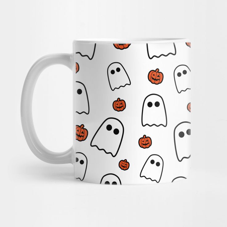 a white coffee mug with halloween ghost faces and pumpkins on the inside, all over it