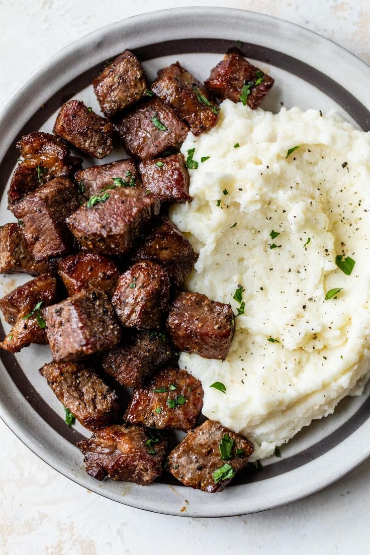 a plate with mashed potatoes and meat on it