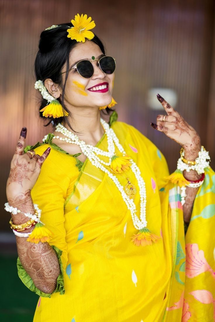 a woman dressed in yellow with flowers on her head