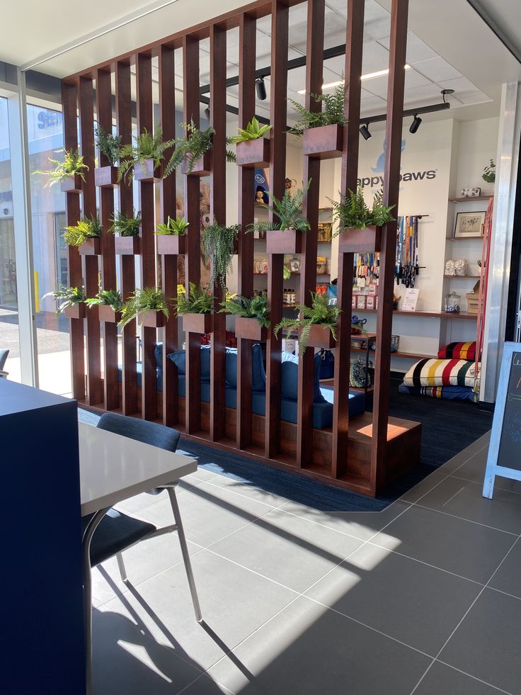 an office with plants growing on the wall