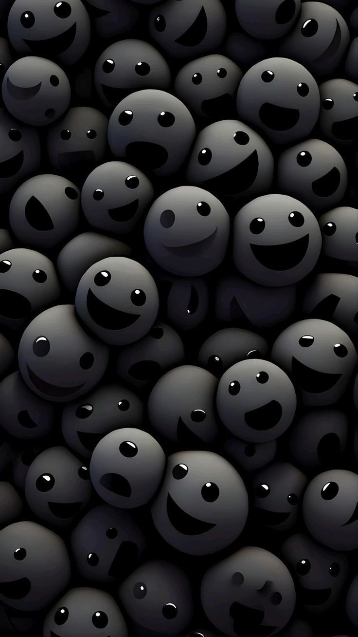 many black balls with faces and eyes are arranged in the shape of an abstract pattern