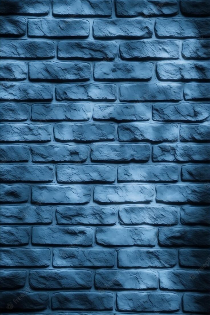 a blue brick wall with some light shining on it