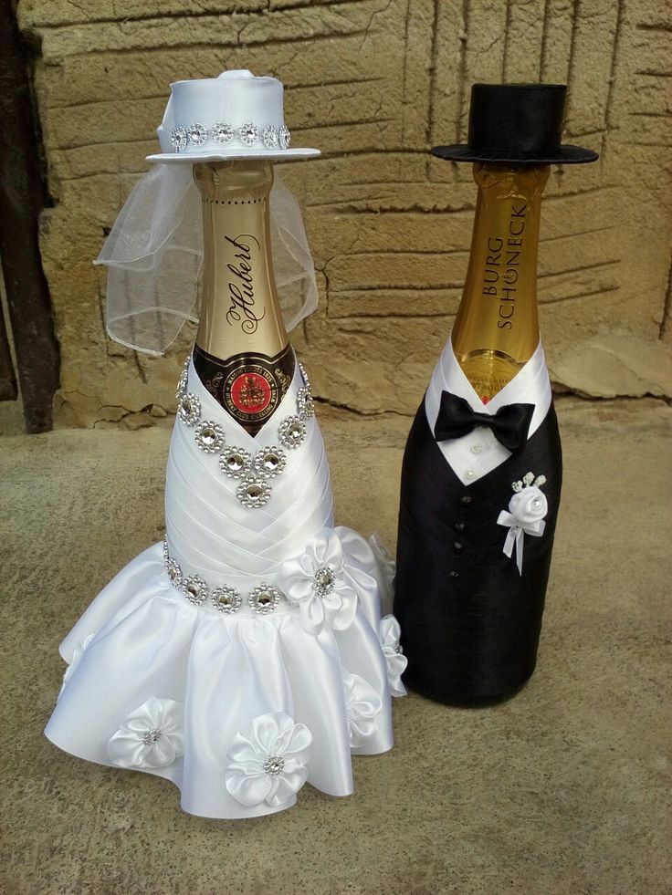 two wine bottles dressed up as bride and groom