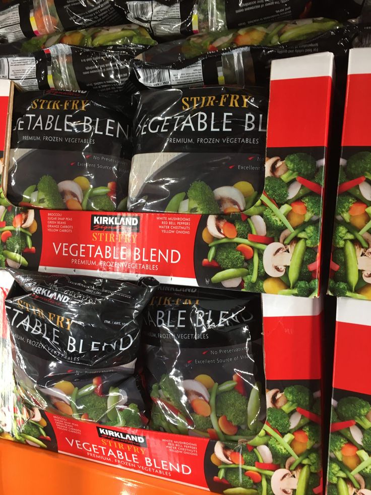 bags of vegetables are on display in a grocery store for $ 3 99 each or more