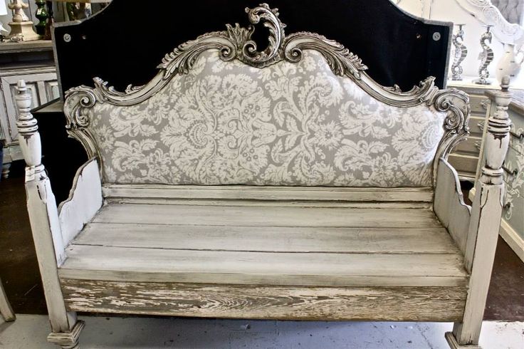 an old white bench sitting in a room