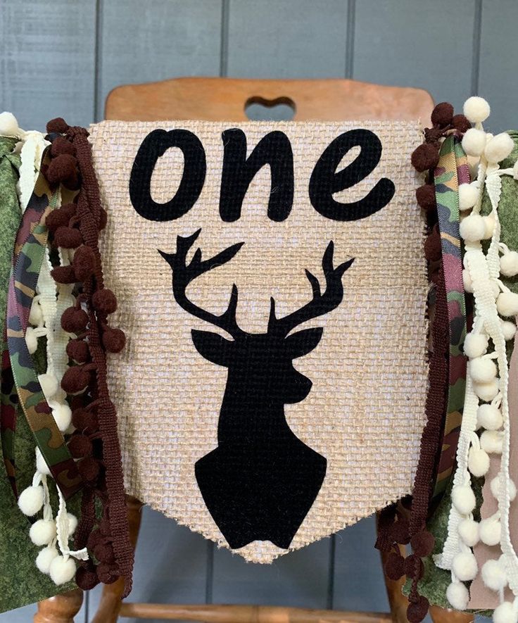 a chair decorated with burlap and pom poms