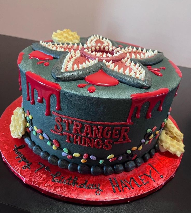 a strange looking cake on top of a red plate with sprinkles and blood