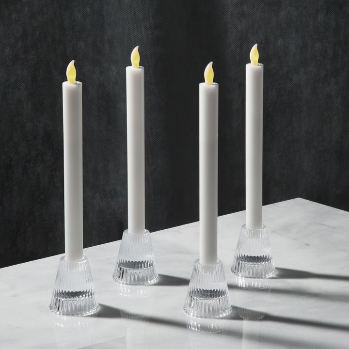 three white candles sitting on top of a table