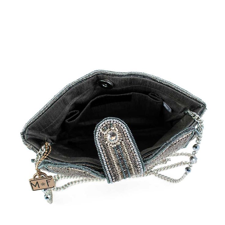 The perfect present, complete with a bow on top. This crossbody handbag is adorned with opulent rhinestones and beads and sure to match any outfit this holiday season. 8 x 1.5 x 8.5" Strap Length End to End: 49" Strap Drop: 22.5" Removable crossbody chain strap, magnet closure, inside pocket, back pocket, metal logo fob, protective storage bag, certificate of authenticity, fits a phone This is a handmade item, each one an individual work of art. Slight variations may occur. More Luxury Beaded Shoulder Bag For Fashion, Embellished Crossbody Shoulder Bag For Party, Luxury Beaded Clutch Shoulder Bag, Evening Rhinestone Crossbody Bag, Chic Hand Embellished Party Bags, Evening Pouch Bag Hand Embellished, Beaded Crossbody Shoulder Bag For Evening, Beaded Evening Crossbody Bag, Evening Shoulder Bag With Rhinestones Crossbody