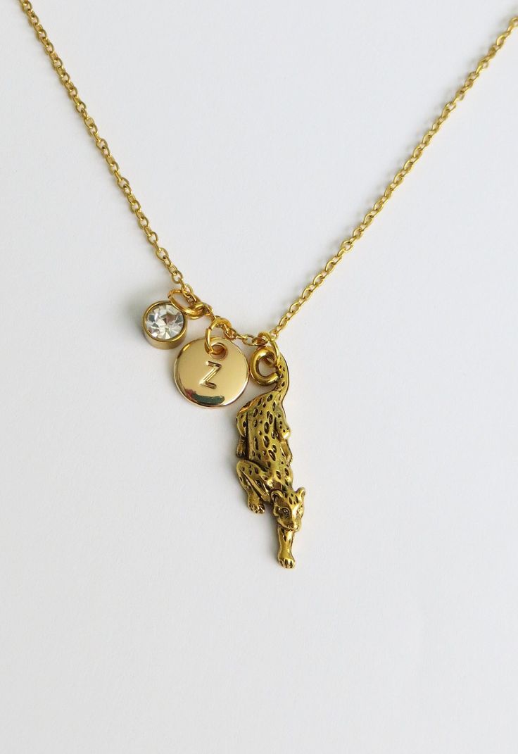 Gold Leopard charm necklace. The necklace is made of gold plated steel chain (45cm approx) with detailed gold plated pewter charm (31mm x 11mm).  Customise your necklace by adding a gold plated double sided initial charm (10mm) or gold plated stainless steel birthstone (6mm) from the drop-down menu when adding the item to cart. It comes in an organza bag ready for gift giving. If you have any questions regarding shipping and payment, please take a look at my shop policies: http://www.etsy.com/uk/shop/LadyMangoJewellery/policy?ref=shopinfo_policies_leftnav ● Shipping: For customers in the UK your order shall arrive within a week though in most cases it's much faster, get in touch if your order is time sensitive and I will do my best to help.  For customers outside the UK, your order can tak Big Necklace Gold, Leopard Jewelry, Leopard Necklace, Necklace Big, Cat Pendant, Charm Necklaces, Cat Pendants, Funky Jewelry, Jewelry Lookbook