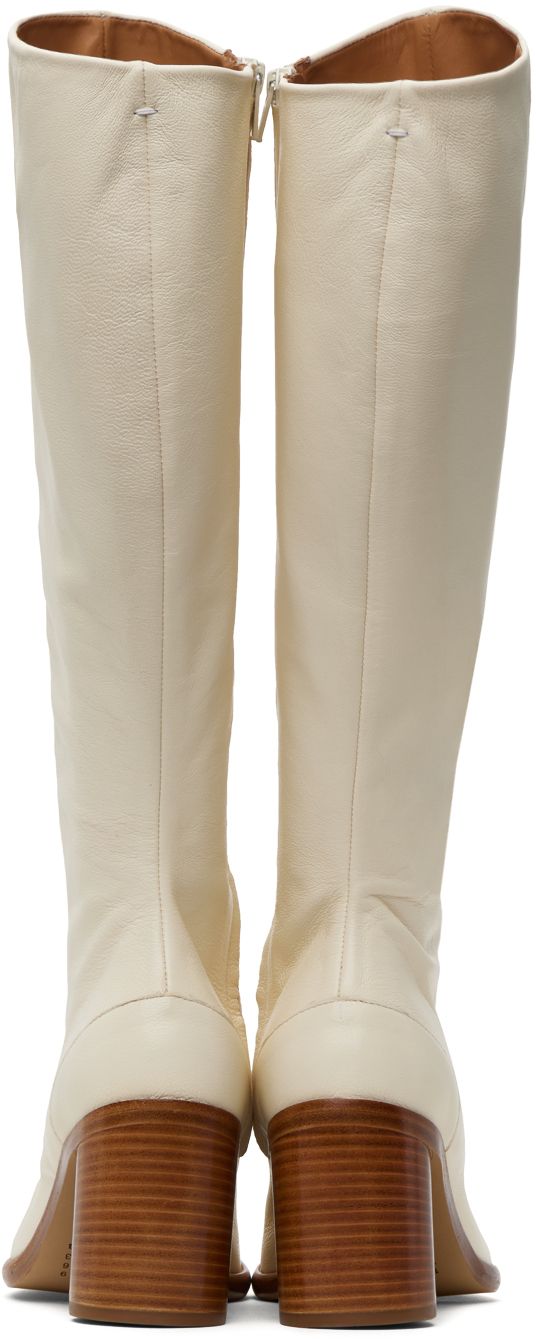 Find MAISON MARGIELA White Tabi Boots on Editorialist. Knee-high grained nappa leather boots in white. · Cleft toe · Zip closure at inner side · Buffed calfskin lining · Stacked leather cylindrical heel with rubber injection · Calfskin sole · Heel: H3 in Supplier color: White White Leather Knee-high Boots With Reinforced Heel, Cream Leather Snip Toe Heeled Boots, Cream Leather Heeled Boots With Snip Toe, White Leather Knee-high Boots With Round Toe, White Leather High Heel Knee-high Boots, White Leather Knee-high Boots For Spring, Spring White Leather Knee-high Boots, Elegant White Leather Knee-high Boots, Elegant White Leather Platform Boots