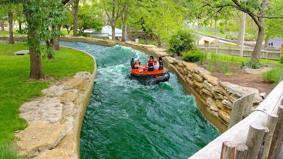 two people in an orange boat going down a river