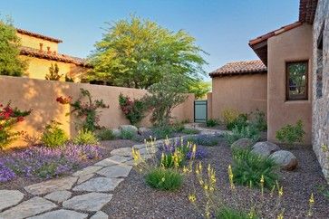 an outdoor garden with rocks and flowers