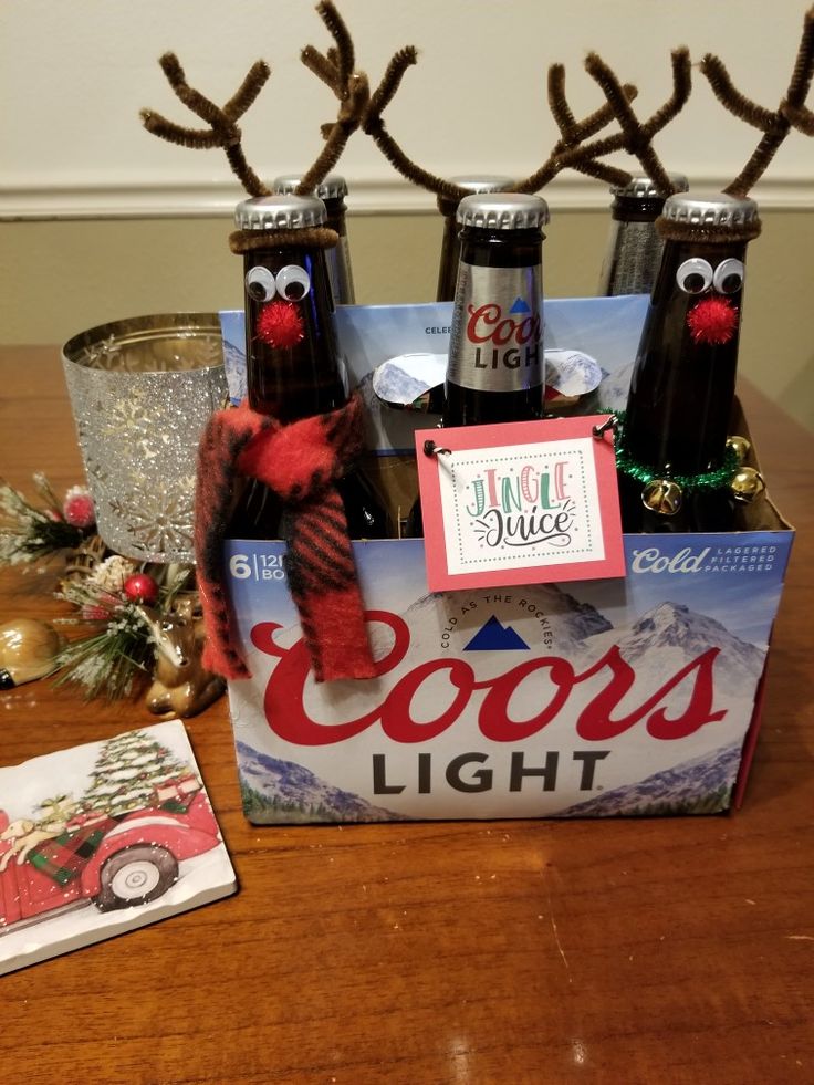 some beer bottles and reindeer antlers are sitting on a table next to a christmas card