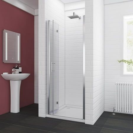 a bathroom with a sink, mirror and shower stall in it's corner area