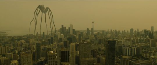 an aerial view of a city with tall buildings and giant kites in the air