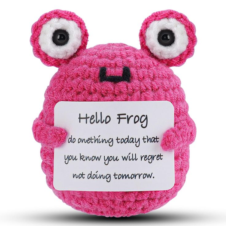 a pink crocheted stuffed animal with eyes holding a sign that says, hello frog do something today that you know you will forget not doing tomorrow