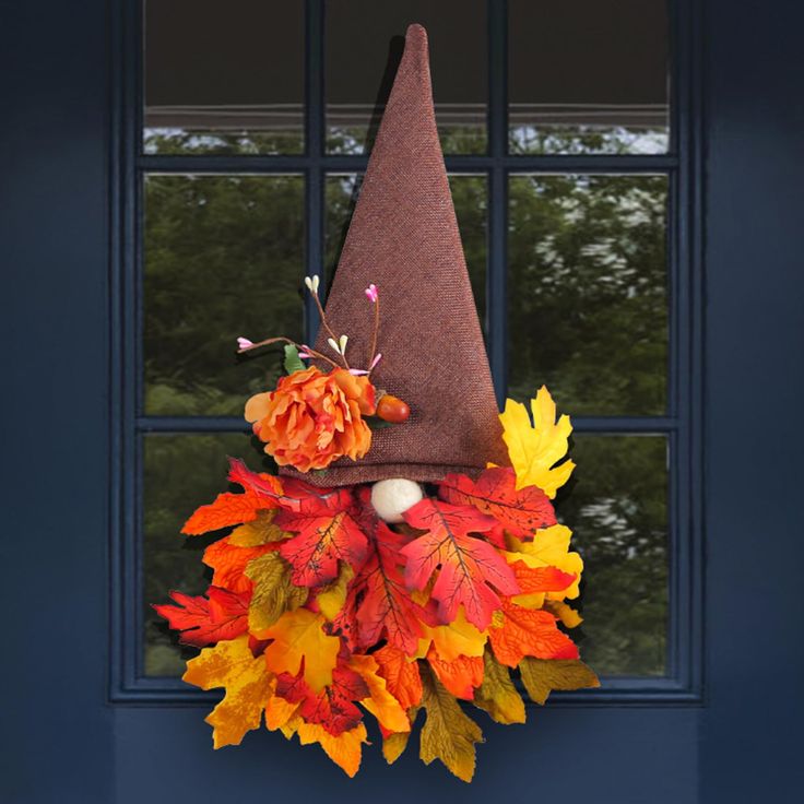 a fall wreath with a gnome's hat on it