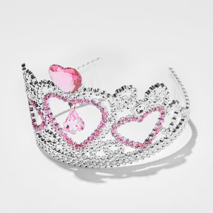 Reign with love with this Claire's Club heart crown! You'll look like royalty wearing the silver-tone crown with a centered pink heart gem, and an assorment of faux gems for an added touch. Add this piece to your dress-up bin for a regal look. Crown by Claire's Club Faux gemstones Material: Plastic Suitable for ages 3-6 - Claire's Club Pink Heart Crown Party Crown With Rhinestones And Structured Shape, Princess Style Jewelry With Crown Design, Pink Crown Headpiece For Wedding, Pink Wedding Crown Headpiece, Pink Pinched Crown For Party, Adjustable Pink Crown With Round Shape, Pink Princess Jewelry For Wedding, Silver Party Crown With Rhinestones, Teardrop Rhinestone Crown For Party