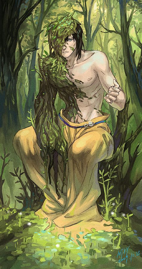 a man with long hair sitting in the woods