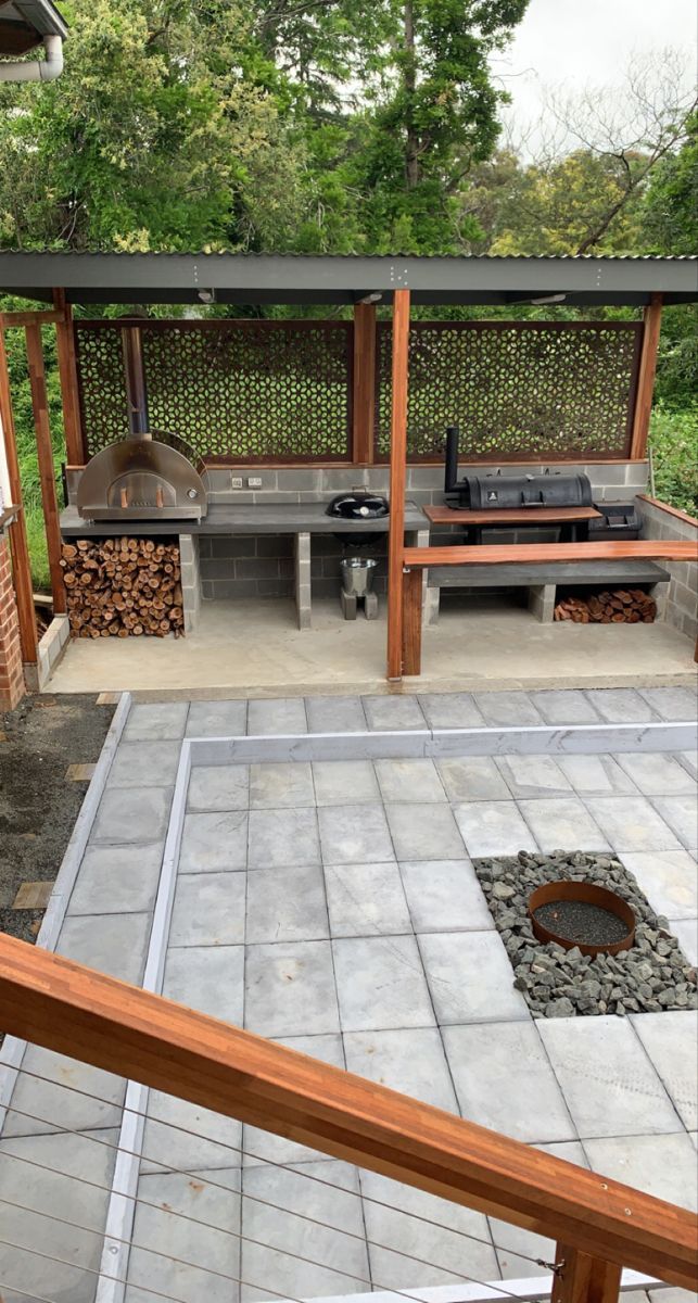 an outdoor bbq with grill and seating area