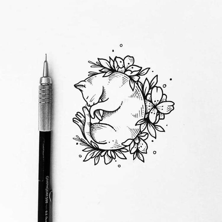 an ink drawing of a cat sleeping in a wreath of flowers