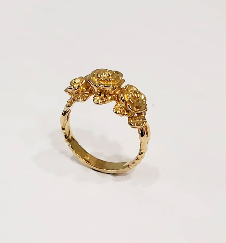 This is my latest ring to my flower collection. The ring is first hand carved in wax then cast into the metal. I love roses and this one especially because 3 roses means I love you. I've paid close attention to detail you will love this ring. Can be ordered in white gold, yellow gold. rose gold, and platinum. Comes is sizes 4 to 10. 100% Money back guarantee. 14k Gold Rose Design Ring, Rose Flower 14k Gold Anniversary Ring, Gold Promise Rings With Rose Design, Elegant Gold Rings With Rose Details, Yellow Gold Flower Ring With Rose Design For Anniversary, Yellow Gold Rose Design Promise Ring, Yellow Gold Jewelry With Roses For Wedding, Yellow Gold Wedding Jewelry With Roses, 14k Gold Anniversary Rings With Rose Design