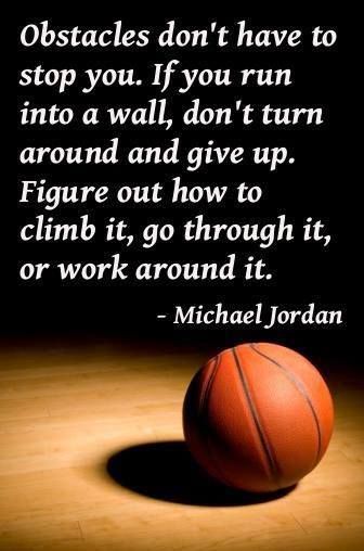 a basketball sitting on top of a wooden floor next to a quote from michael jordan