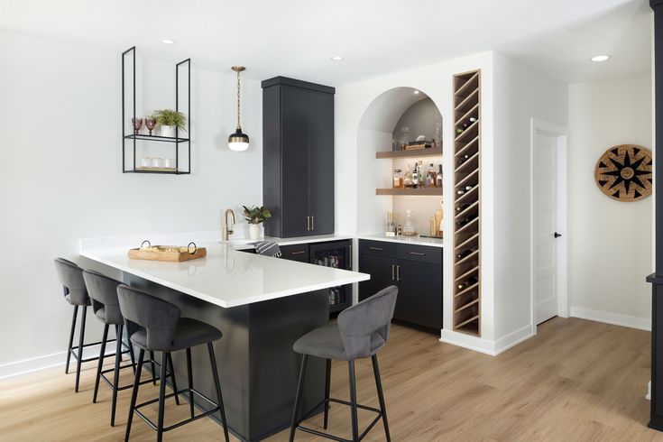 a kitchen with black cabinets and white counter tops