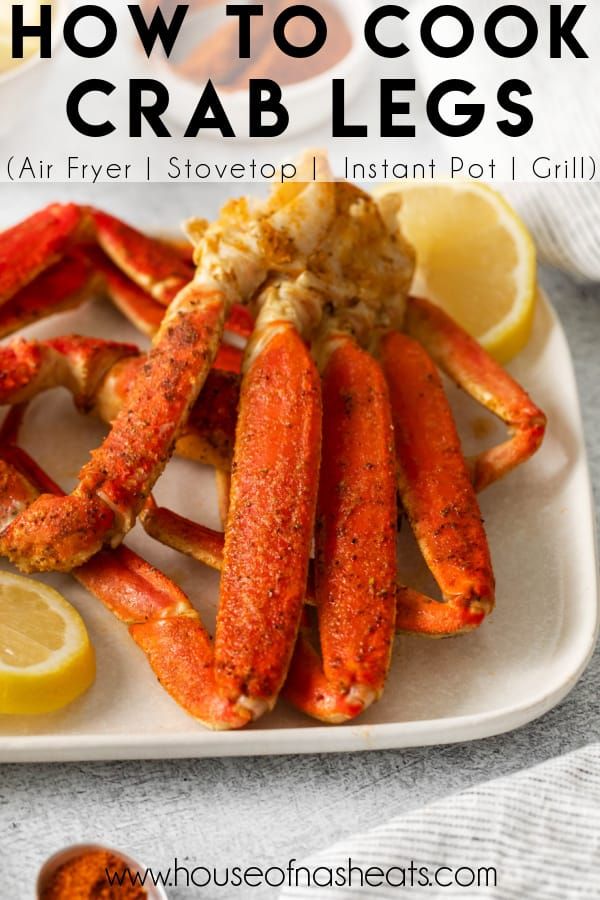 crab legs on a plate with lemon wedges