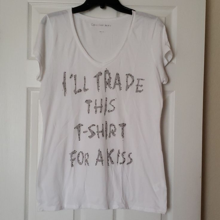 Nwot, Calvin Klein White V Neck T-Shirt With Gray Lettering With Raised Details On Letters. Cute T-Shirt Says " I'll Trade This T-Shirt For A Kiss". Calvin Klein Cotton T-shirt With Letter Print, Calvin Klein White Short Sleeve Shirt, White Short Sleeve Calvin Klein Shirt, Calvin Klein Graphic Tee Crew Neck, Calvin Klein Graphic Tee Short Sleeve T-shirt, Calvin Klein Graphic Tee Short Sleeve, Calvin Klein Graphic Tee With Crew Neck, Calvin Klein Graphic Tee With Short Sleeves, Calvin Klein Cotton Short Sleeve Tops