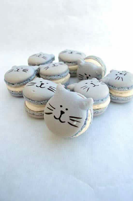 a bunch of cat cookies sitting on top of a table