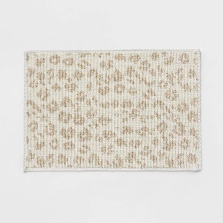 a white and brown leopard print rug