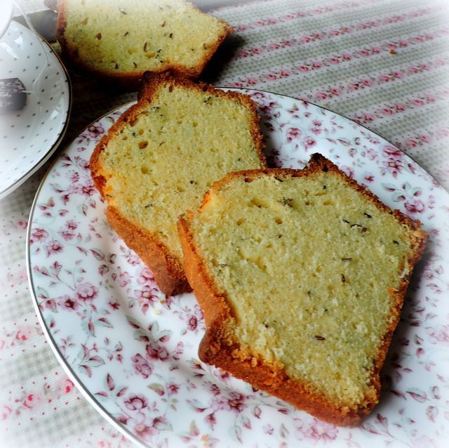 two slices of cake on a plate next to a cup and saucer