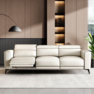 a modern living room with white leather furniture