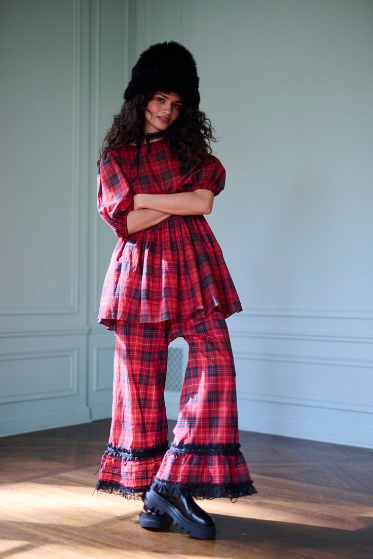 Inspired by Selkie founder Kimberley Gordon’s childhood in the UK, this Royal Tartan Pant Set nods to Buckingham Palace and the queen. The relaxed babydoll top features mid-length elastic puff sleeves and a sweet keyhole back with fabric-covered button - perfect for holiday tea time. The ankle-skimming pants, complete with delicate lace ruffles and ribbon-cinched cuffs, add a whimsical nod to royal guards. With side button closures and a half-elastic waistband, this set captures the magic of Tra Blue Christmas Outfit, Eclectic Clothing Style, Cotton Gauze Pants, Royal Guards, Pant Design, Holiday Tea, Gauze Pants, Tartan Pants, Skirt Swimsuit