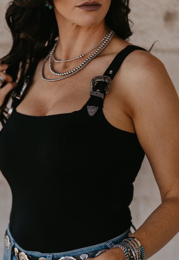 This trend is on point! Buckle strap tank top...and get this, they're adjustable! Has a build in bra so the top half is double lined. Has great stretch and runs true to size. Semi-Fitted. Material: 60% Cotton | 40% Polyester Small (2/4) | Medium (6/8) | Large (10/12) | XL (14/16) | 2XL (18/20) Buckle Strap Top, Strap Tank Top, Tank Top Straps, Strap Top, Fancy Outfits, Strap Tops, Black Tank Tops, Buckle, Tank Top