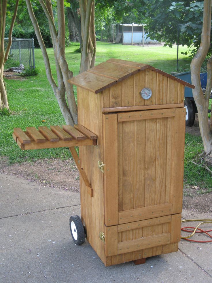 a wooden trash can sitting on top of a sidewalk