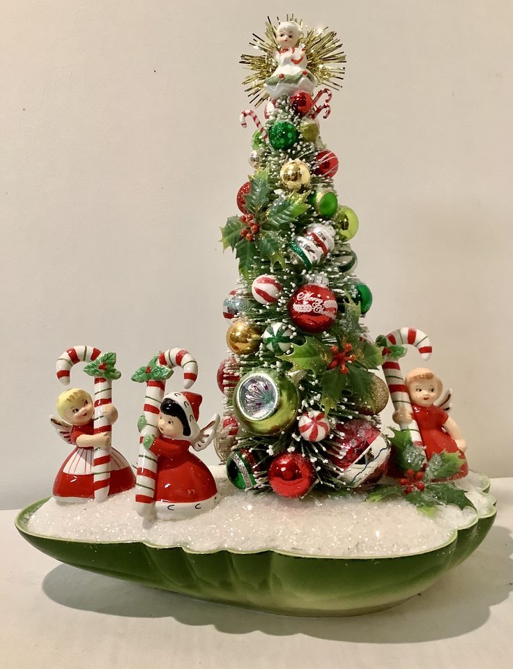 a small christmas tree with ornaments on it