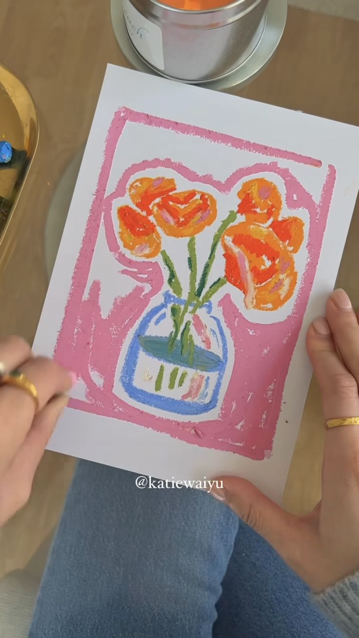 a person is drawing flowers in a vase