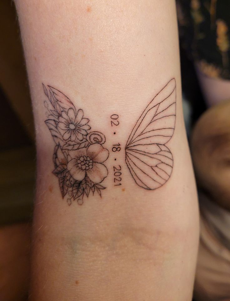 a butterfly tattoo with flowers on its wings