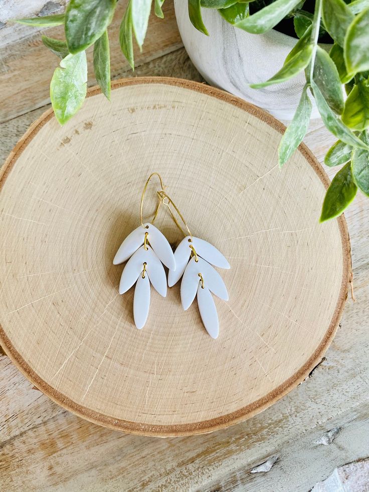 These fun hoop earrings have been handmade with polymer clay. All colors are mixed by hand giving them a unique look. These are truly one of a kind! The hoops are gold plated brass and are nickel free, making these great for sensitive ears. The hoops are about 1 inch in diameter. The clay leaves are about 1.5 inches in length. The total length of the earrings is about 2.5 inches. These earrings are super lightweight and so comfortable to wear! Very cute for Summer! Be sure to check out our shop Handmade Polymer Clay Dangle Hoop Earrings, Handmade Polymer Clay Hoop Earrings, Adjustable White Polymer Clay Hoop Earrings, Adjustable White Hoop Earrings In Polymer Clay, Handmade Gold Hoop Earrings With Polymer Clay, Dangle Hoop Earrings In Polymer Clay, Small Hoop Polymer Clay Earrings For Everyday, Everyday Small Hoop Earrings In Polymer Clay, Unique White Hoop Earrings With Ear Wire