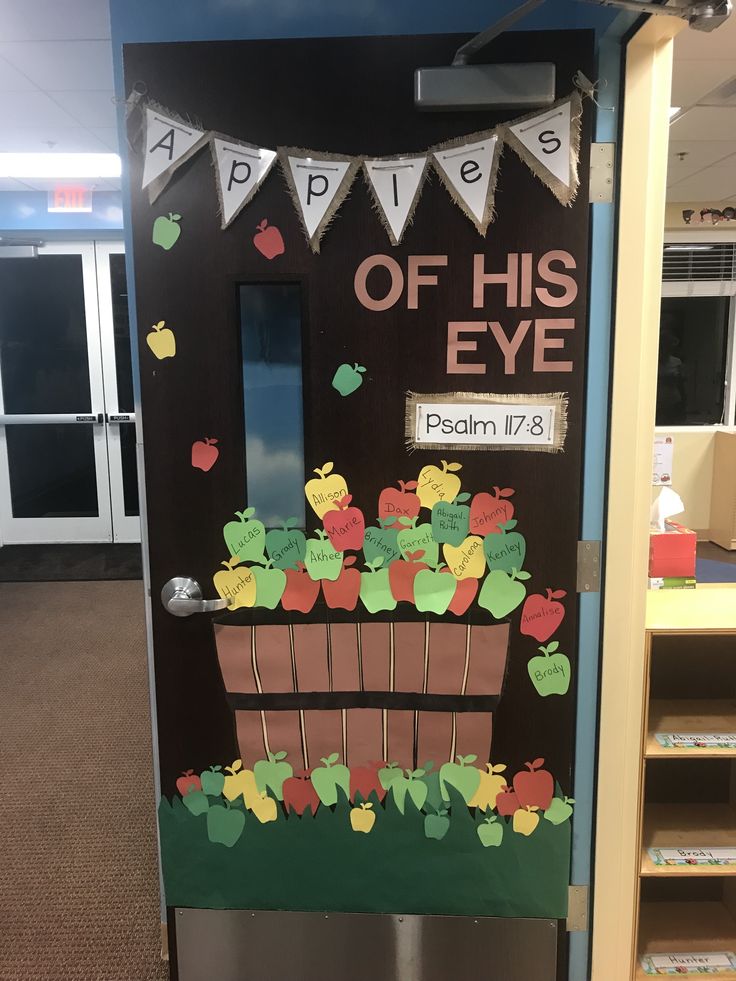 a door decorated with apples and flowers for an apple themed school year classroom door decorations