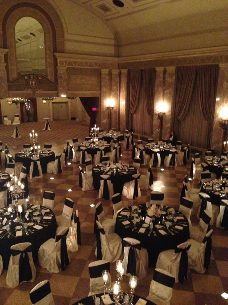 an elegant ballroom with black and white linens