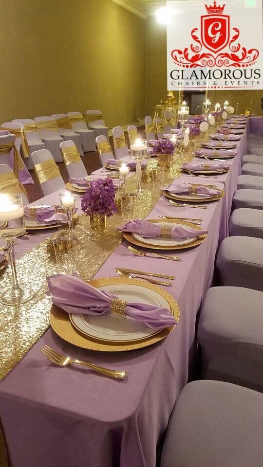 a long table with purple and gold place settings