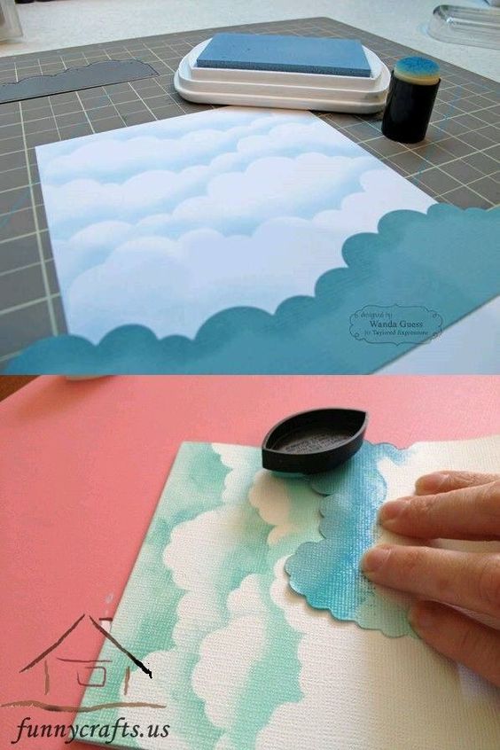 a person is painting clouds on a piece of paper