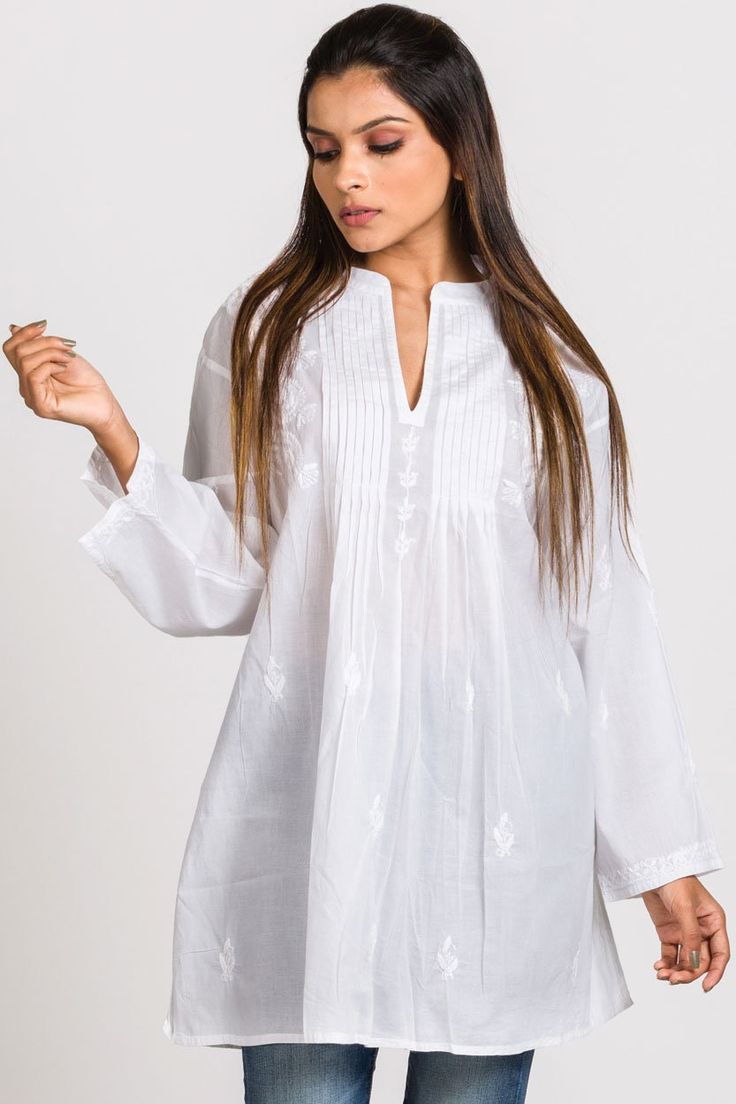 "Our Kamalika Tunic is hand embroidered by women artisans in Northern India in the shadow-work style known as \"Chikankari\". Chikankari is a delicate and artfully done hand embroidery technique that women in this region have been doing for generations. Available in two sizes, S/M and L/XL, this beautiful 100% cotton tunic is designed for a comfortable and elegant fit." Festive Embroidered Top For Eid, Straight Kurta With Resham Embroidery For Rituals, Resham Embroidery Straight Kurta For Rituals, Bohemian Chanderi Kurta With Cutdana, Transitional Cutdana Kurta, Embroidered Straight Kurta Top In Chanderi, Embroidered Chanderi Straight Kurta Top, Chanderi Blouse With Embroidered Border For Navratri, Navratri Chanderi Blouse With Embroidered Border