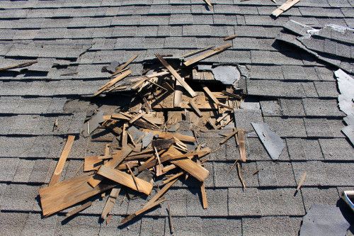 debris on the roof of a house that has been gutted with wood shingles